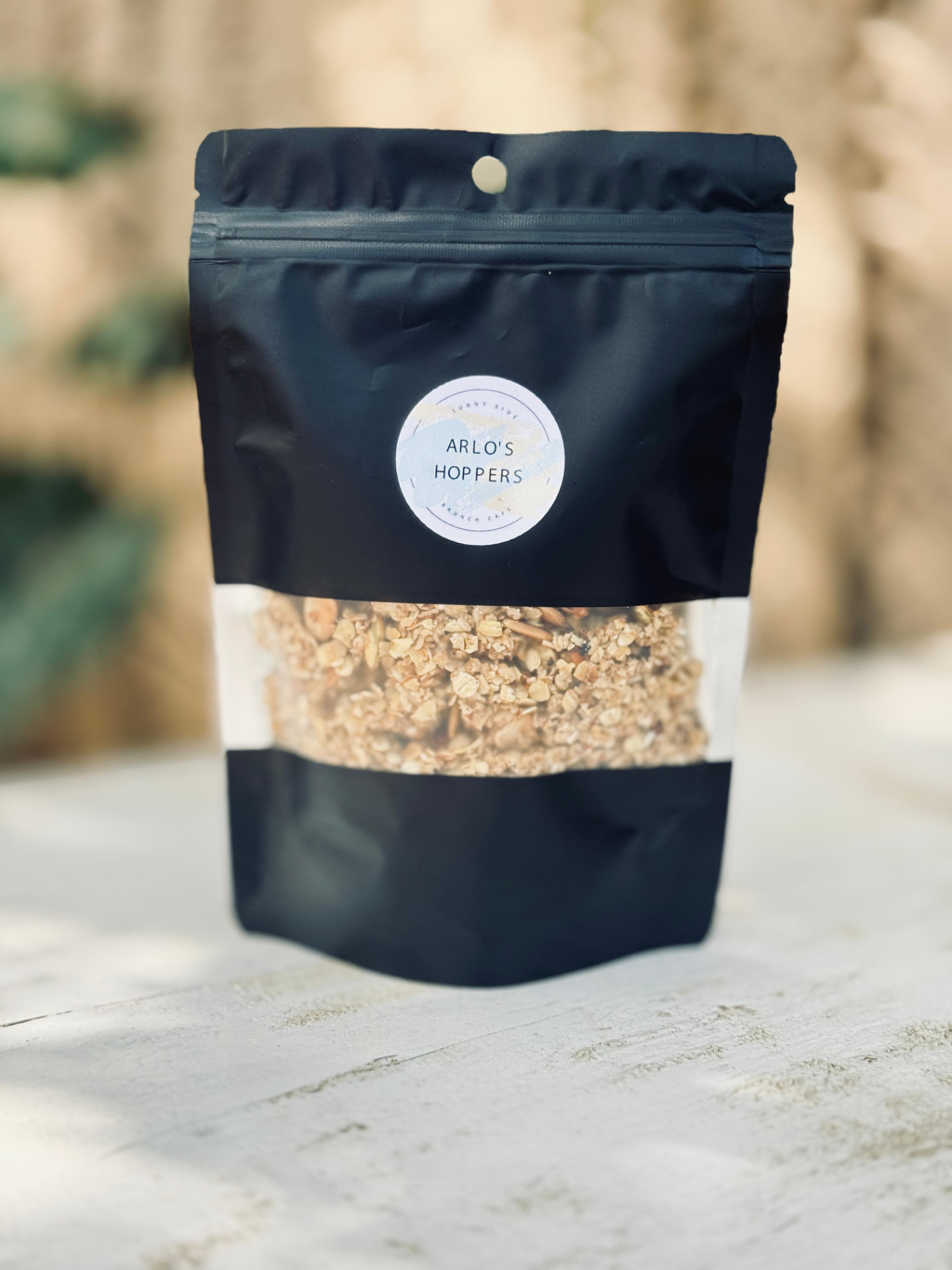 Golden homemade granola pack with the Arlo's Hoppers label