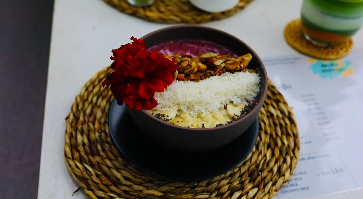 Smoothie bowl topped with granola, banana and coconut