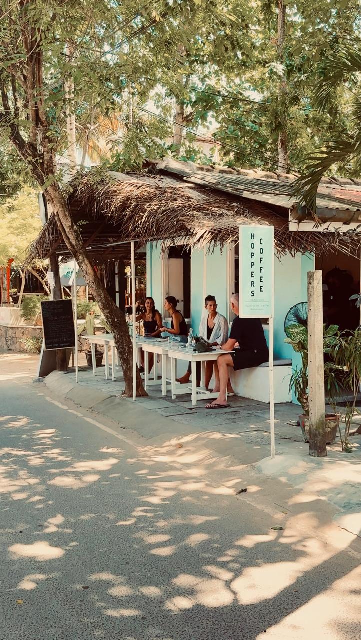 The Arlo's Hoppers café exterior with guests seated at the street-side counter